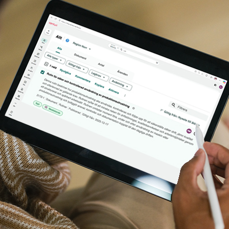 image of a hand holding an ipad